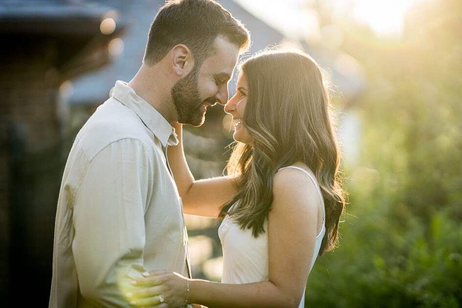 Romantic golden hour engagement photo with couple embracing showing perfect lighting and styling for what to wear guide