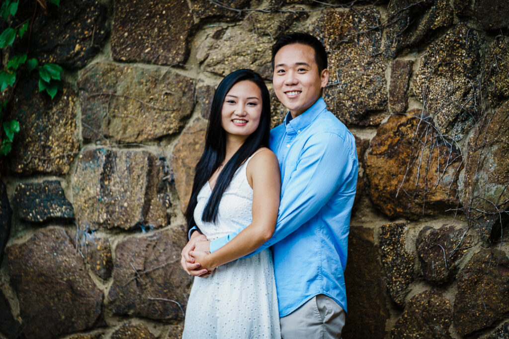 Happy couple looking up during overhead engagement photo at Deep Cut Gardens