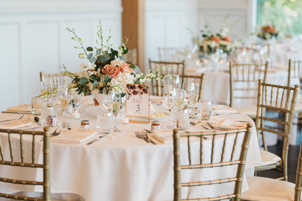 Reception table settings with coral floral arrangements at The View.