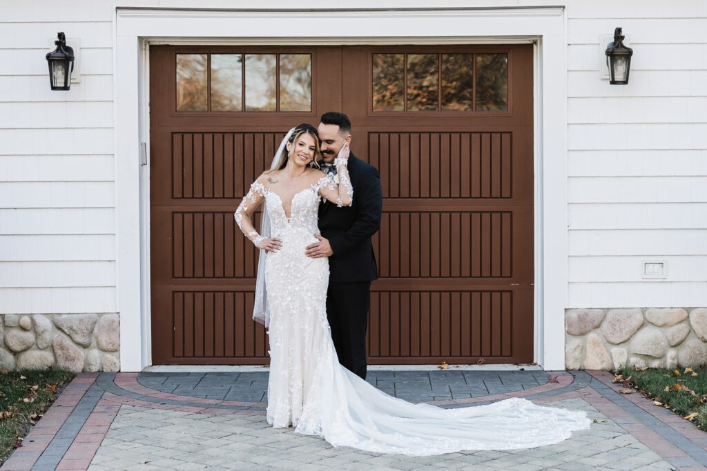 Wedding couple portrait in front of wooden garage door at The English Manor Ocean Township NJ