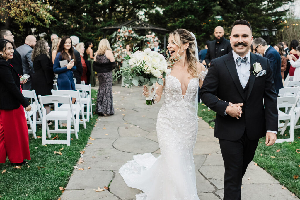 Couple making entrance to cocktail hour at The English Manor wedding celebration