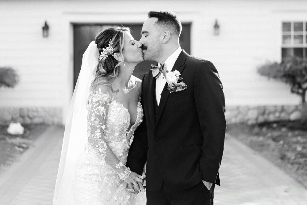 Black and white photo of bride and groom kissing at The English Manor Ocean Township wedding