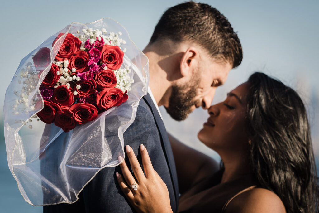 Couple detail with roses at Chart House Weehawken engagement by Alex Kaplan Photography
