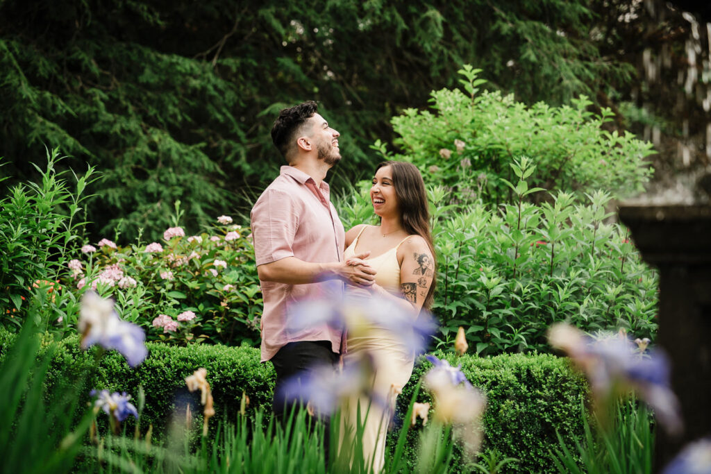 Alex Kaplan Northern New Jersey engagement photographer documents joyful couple laughing among purple iris flowers