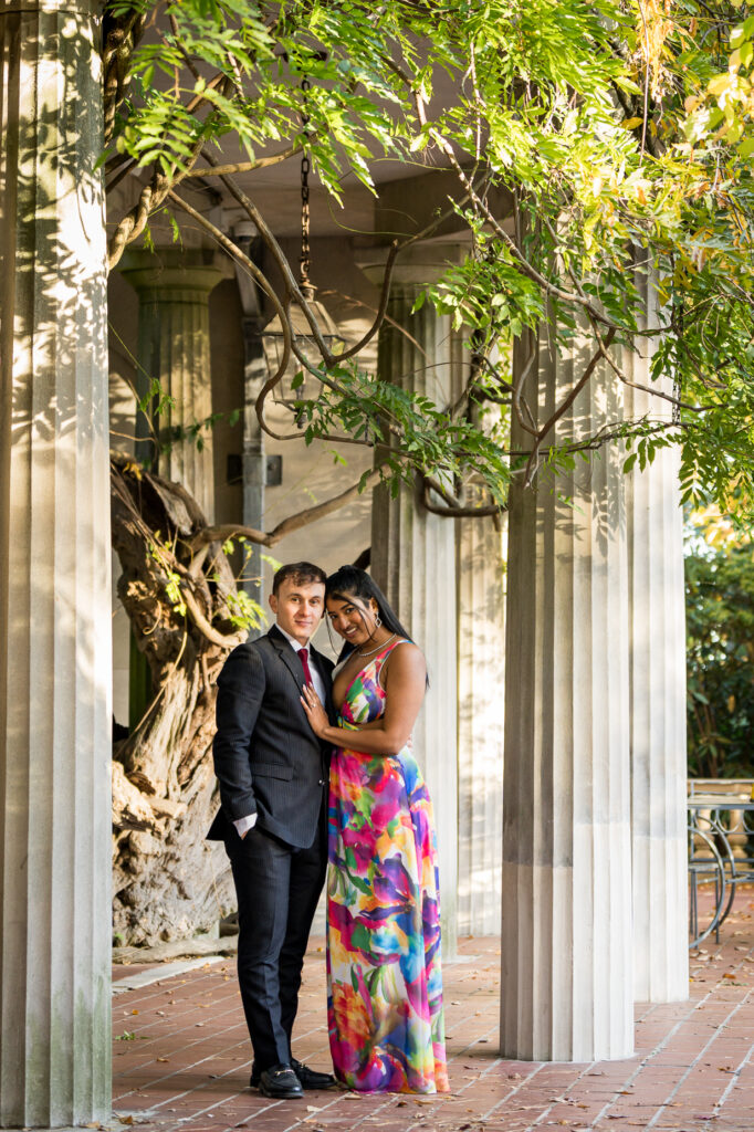 Close-up of engagement ring as couple poses together during fall garden portrait session