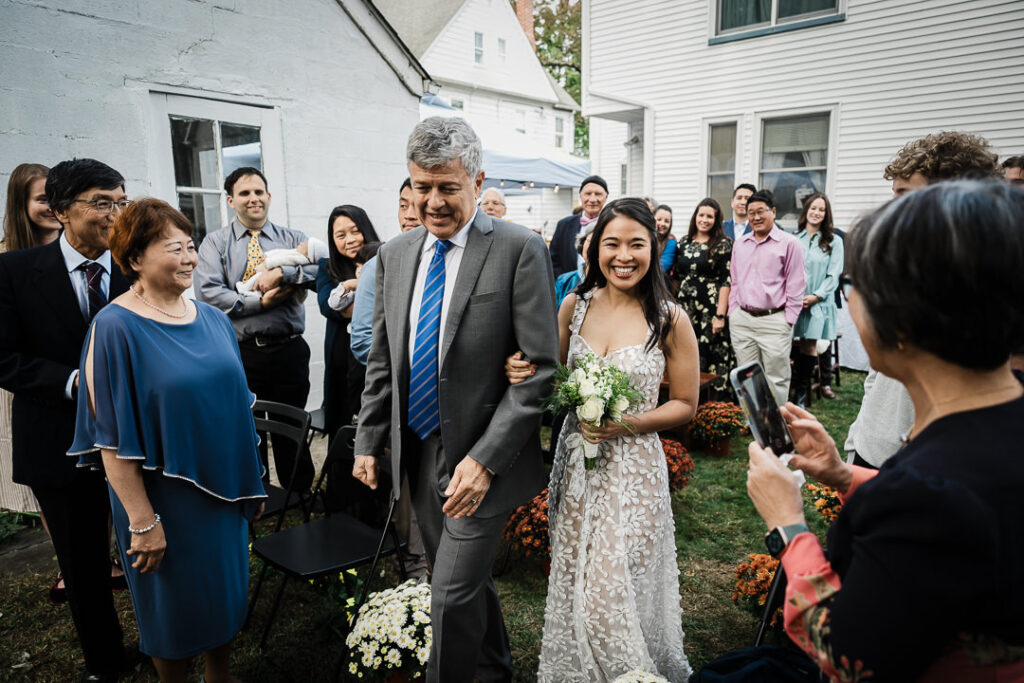 Father of bride walking daughter down aisle at intimate backyard wedding in NJ