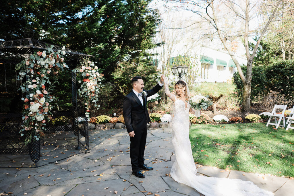 Couple's first look moment at The English Manor with outdoor ceremony gazebo in background