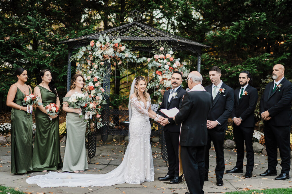 Full wedding ceremony with bridesmaids in teal and sage dresses and groomsmen at The English Manor gazebo