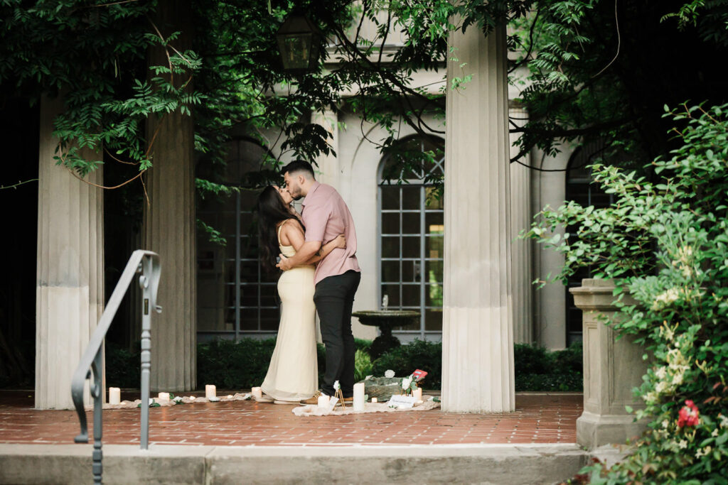 Bergen County wedding photographer Alex Kaplan photographs newly engaged couple kissing at romantic garden proposal venue