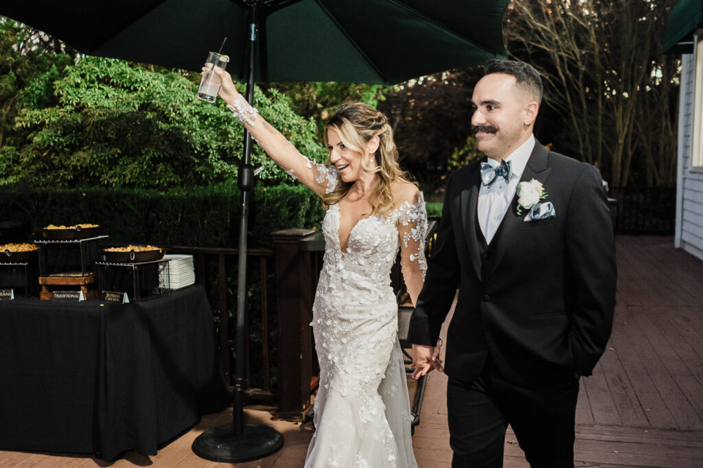 Bride and groom making fun grand entrance with sunglasses at The English Manor reception