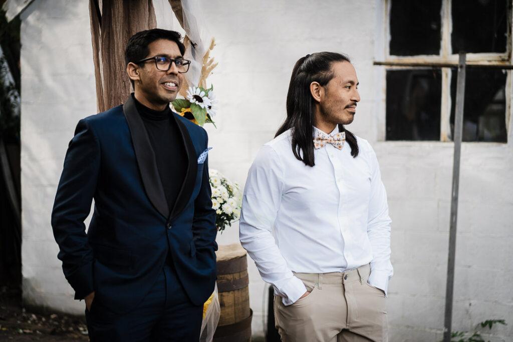 Groom with groomsman preparing for backyard wedding ceremony in NJ