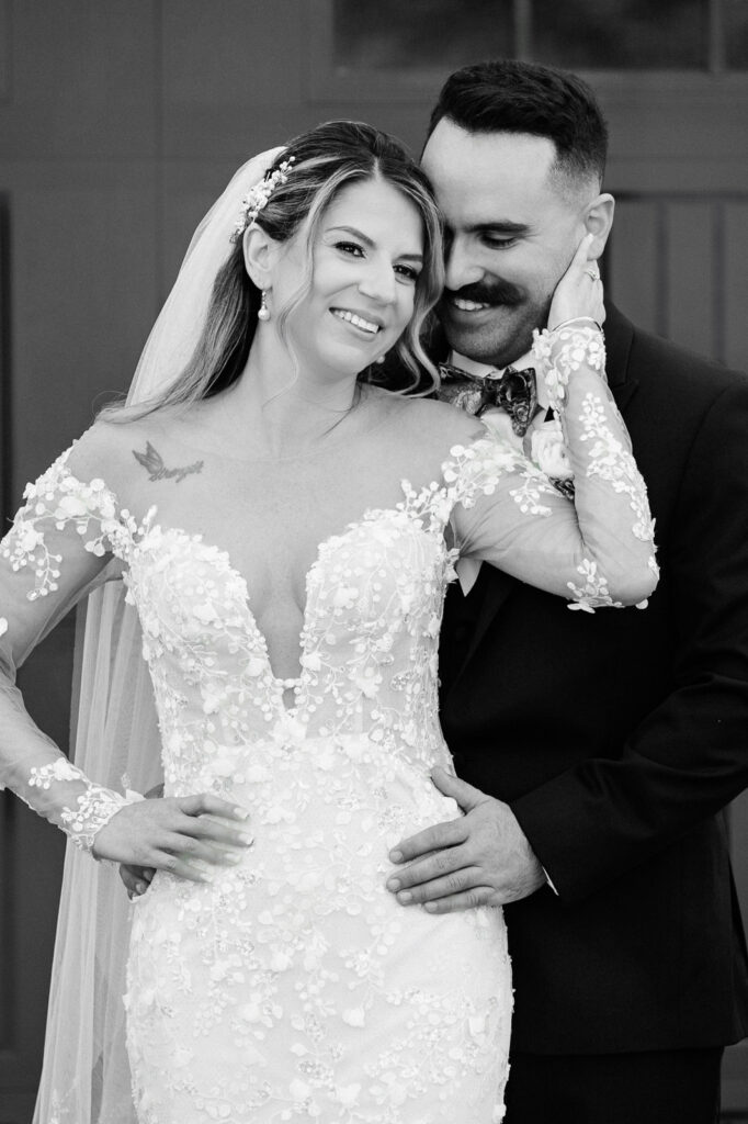 Black and white intimate portrait of bride and groom embracing at English Manor wedding