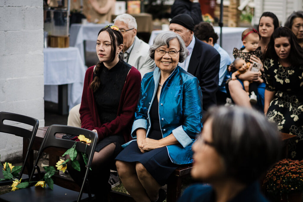 Guests watching intimate backyard wedding ceremony with joy in NJ