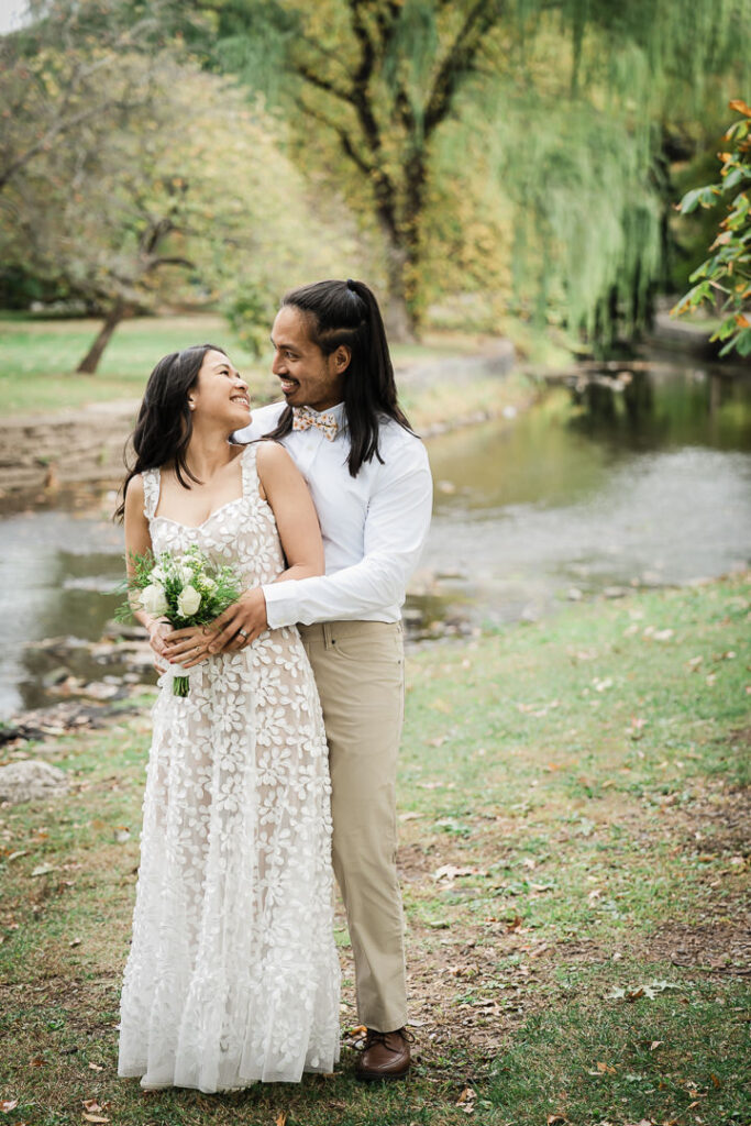 Newlyweds sharing a quiet moment on the footbridge at Kingsland Park in Nutley, NJ