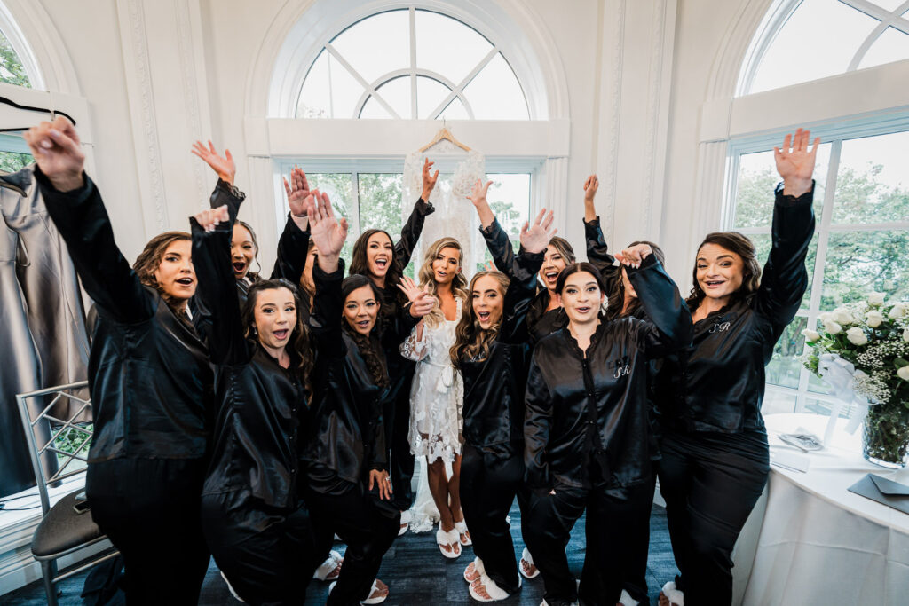 Bridal party celebrating in Legacy Castle bridal suite photographed by Alex Kaplan