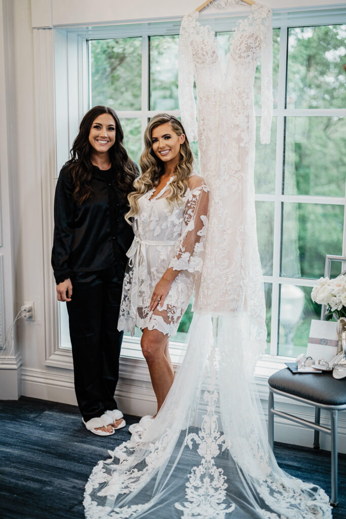 Bride with bridesmaid in black robes at Legacy Castle wedding by Alex Kaplan Photography