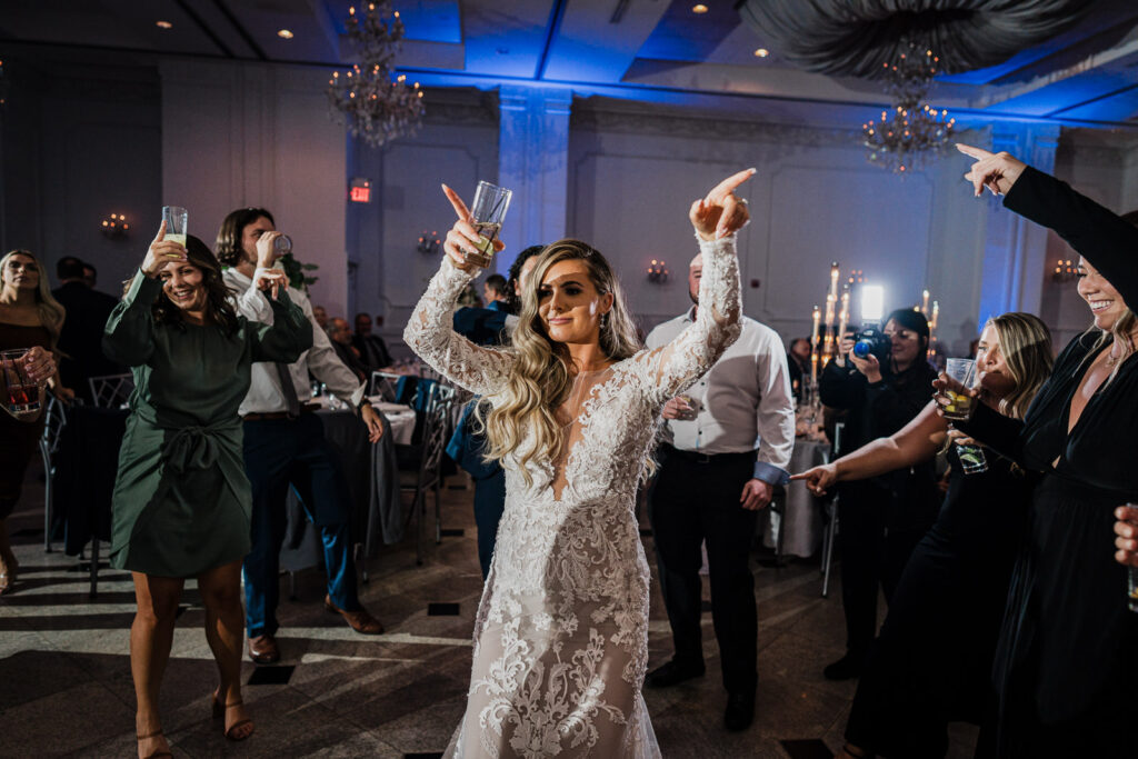 Bride celebrating and dancing at The Legacy Castle reception by Alex Kaplan