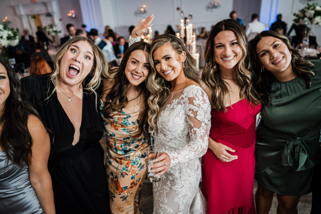 Bride with friends during reception at The Legacy Castle photographed by Alex Kaplan
