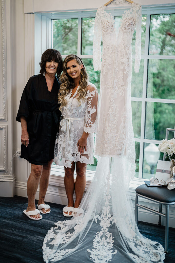 Bride with mother getting ready at The Legacy Castle bridal suite photographed by Alex Kaplan