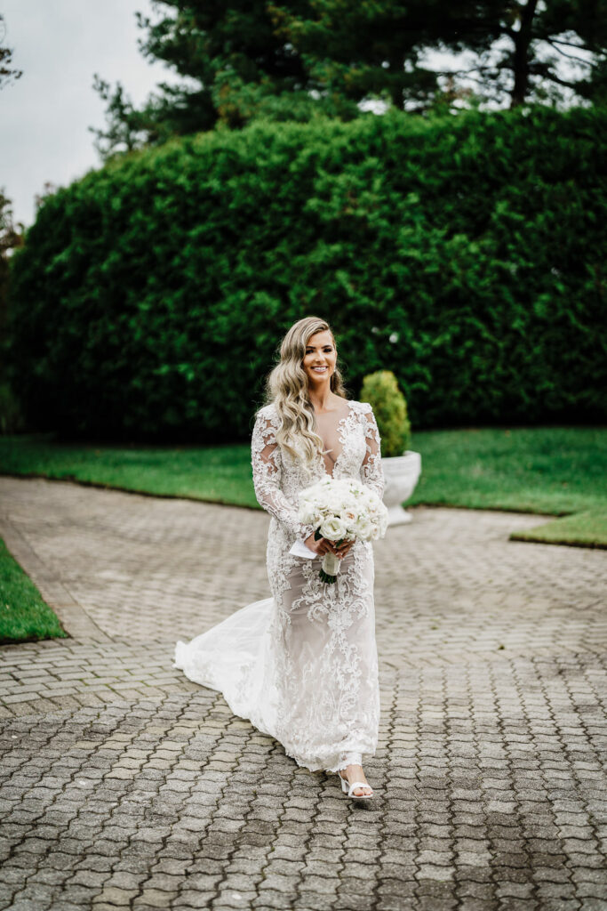 Bride walking on Legacy Castle grounds with bouquet photographed by Alex Kaplan