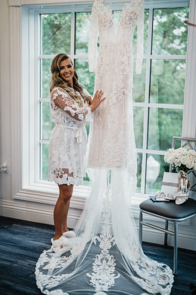 Bride in white floral robe with wedding dress at Legacy Castle Pompton Plains NJ by Alex Kaplan Photography