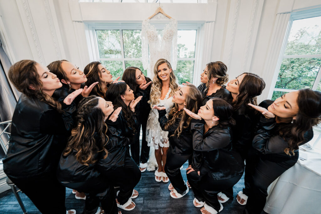 Bridesmaids kissing bride during getting ready at The Legacy Castle by Alex Kaplan Photography