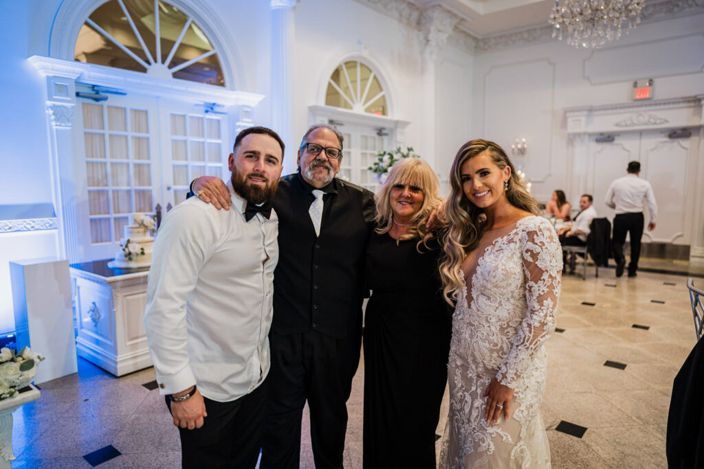 Couple with both sets of parents at The Legacy Castle wedding by Alex Kaplan