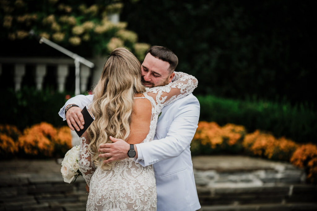 Couple embracing during first look at Legacy Castle Pompton Plains by Alex Kaplan