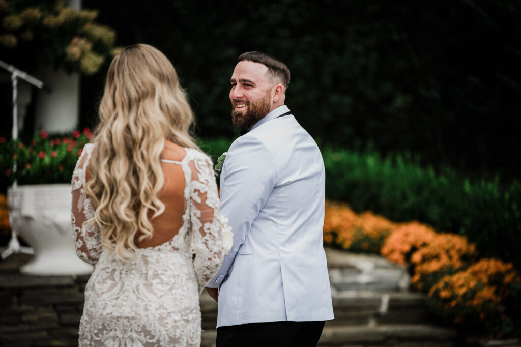Groom smiling during first look reveal at The Legacy Castle by Alex Kaplan Photography