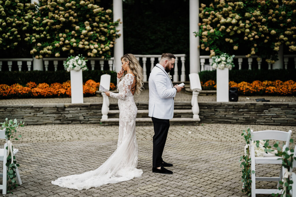 Couple doing first look reading vows at Legacy Castle Pompton Plains by Alex Kaplan