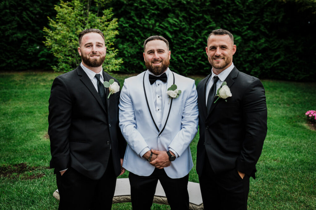 Groom with best men in white dinner jacket at The Legacy Castle by Alex Kaplan