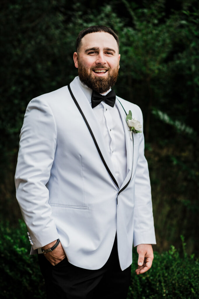Groom portrait in white dinner jacket at Legacy Castle Pompton Plains NJ by Alex Kaplan Photography