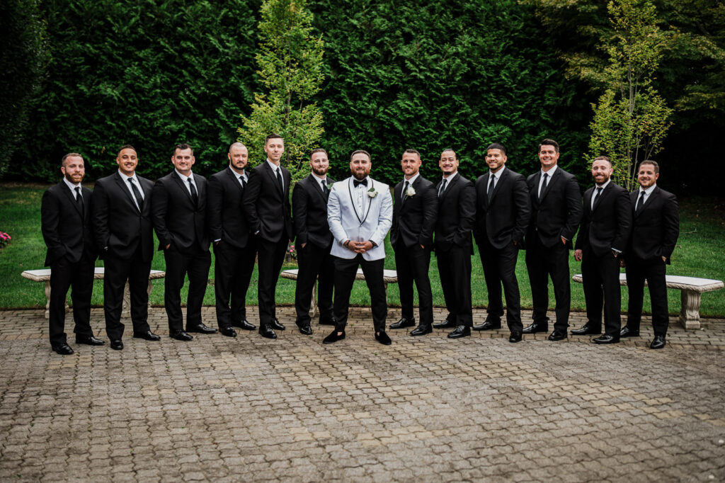 Groom with groomsmen in black tuxedos at The Legacy Castle Pompton Plains by Alex Kaplan