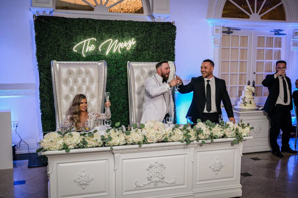 Groomsmen celebrating during toasts at Legacy Castle Pompton Plains by Alex Kaplan Photography