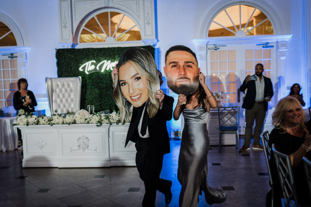 Wedding hora with oversized face cutouts at Legacy Castle Pompton Plains by Alex Kaplan Photography