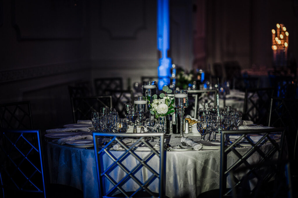 Reception tablescape with tall candle centerpieces at The Legacy Castle photographed by Alex Kaplan