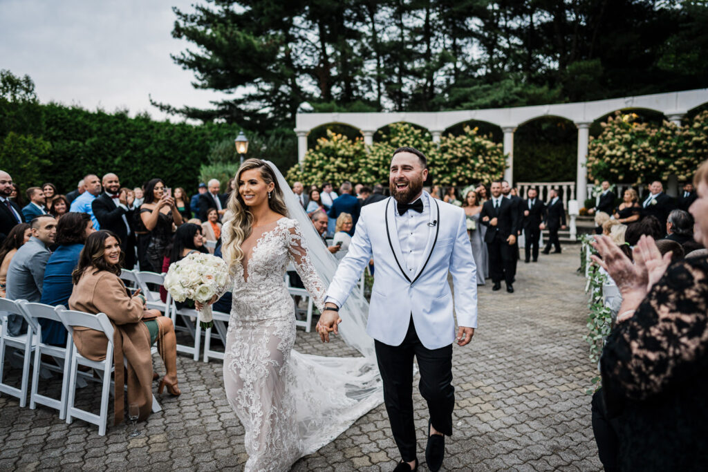 Happy couple during wedding recessional at The Legacy Castle photographed by Alex Kaplan