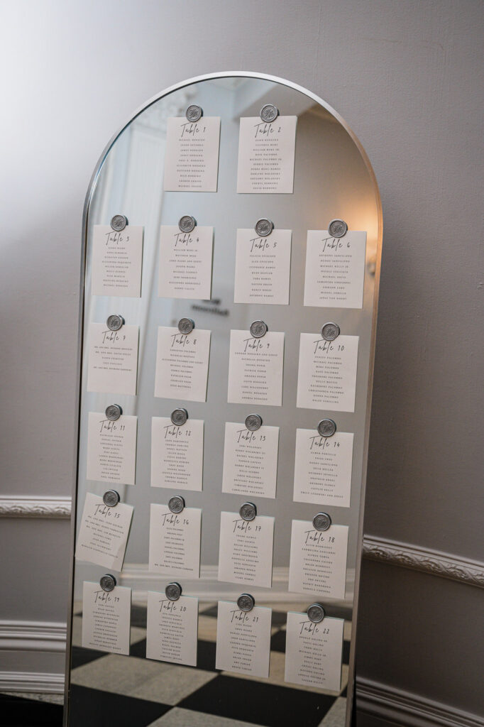 Mirror seating chart with calligraphy at The Legacy Castle wedding by Alex Kaplan