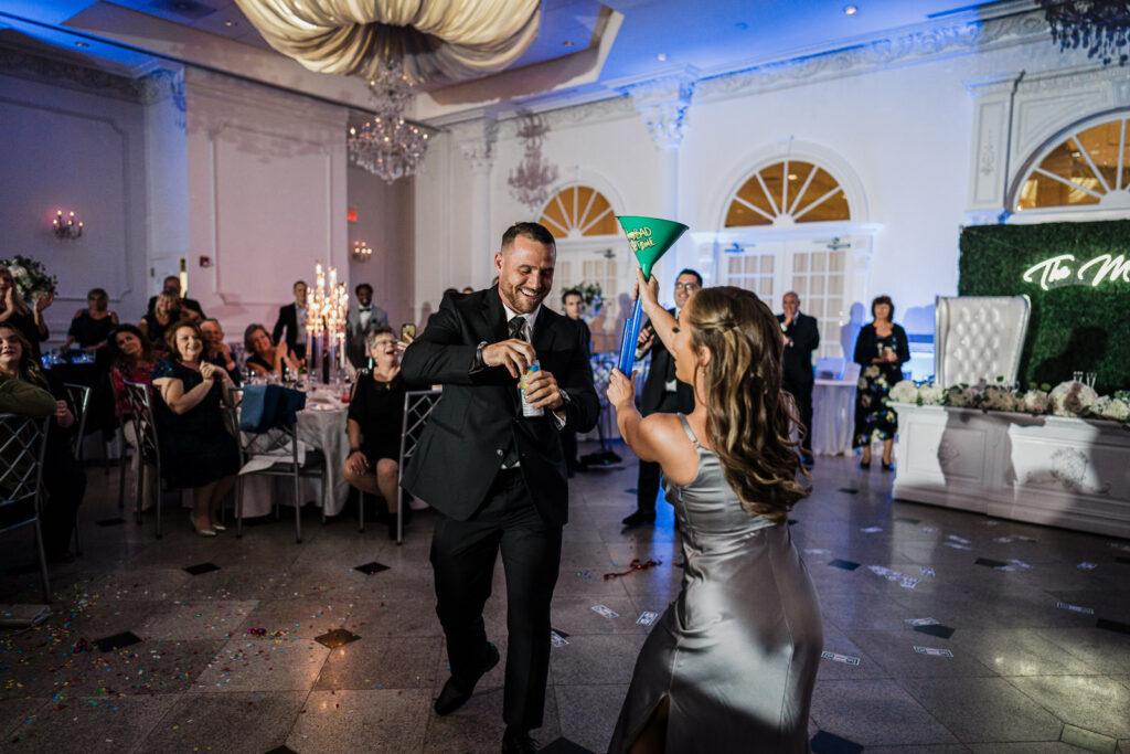 Entire wedding party celebrating during hora at The Legacy Castle by Alex Kaplan