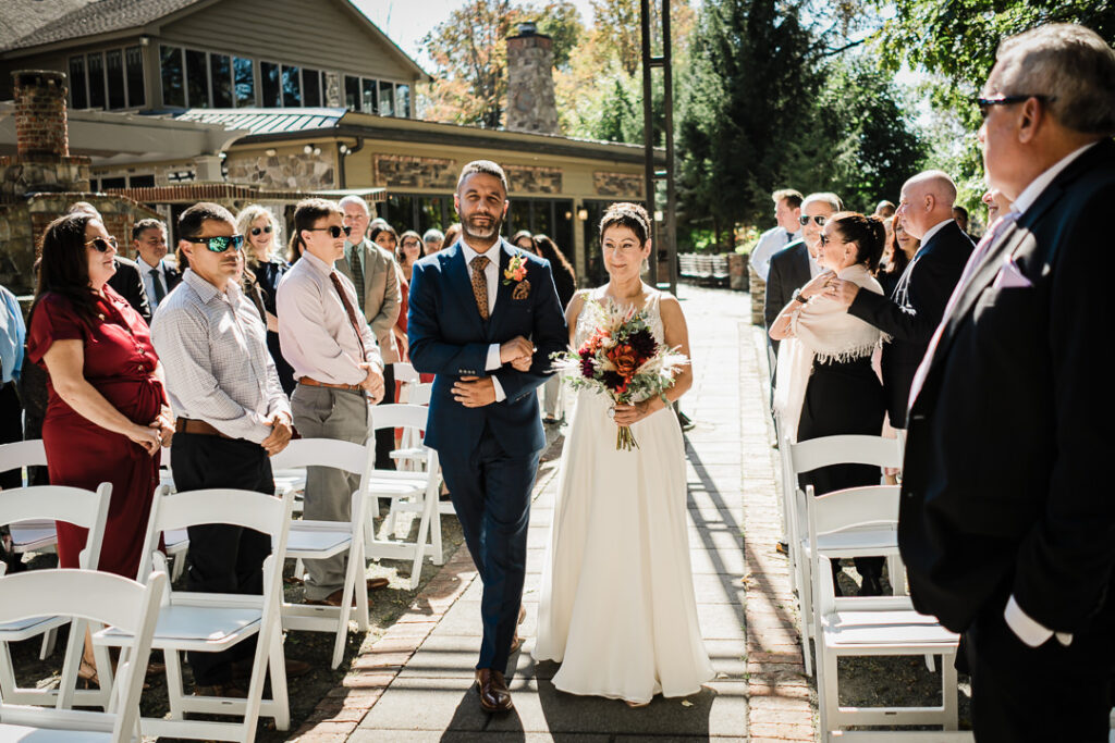 Bride walks down aisle during outdoor ceremony at Mohawk House wedding in Sparta New Jersey by Alex Kaplan Photography