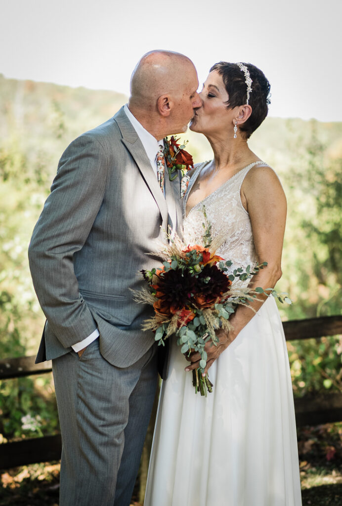 Wedding couple kisses during outdoor portrait session at Mohawk House venue in Sparta New Jersey by Alex Kaplan