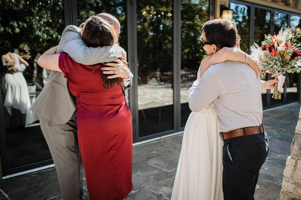 Guests embrace couple after outdoor ceremony at Mohawk House wedding venue Sparta New Jersey by Alex Kaplan