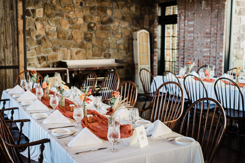 Close up of fall wedding centerpieces with copper runner at Mohawk House Sparta NJ by Alex Kaplan Photography