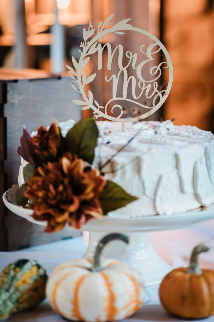 White wedding cake with Mr and Mrs topper and fall pumpkin decor at Mohawk House venue Sparta New Jersey by Alex Kaplan