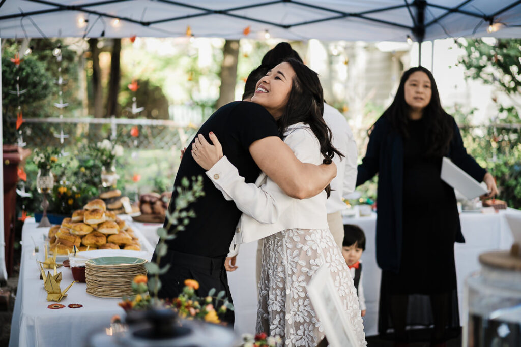 Bride celebrating with guests under tent at outdoor wedding reception in NJ