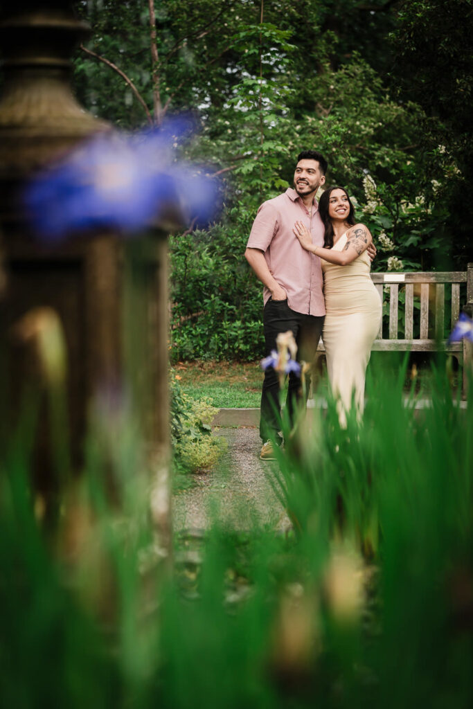 Northern NJ engagement photographer Alex Kaplan captures romantic moment near garden bench surrounded by irises