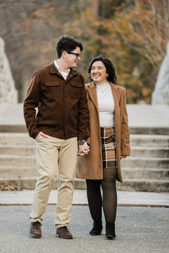 Shannon and Aidan walking hand in hand during fall engagement session at Verona Park by Alex Kaplan Photography