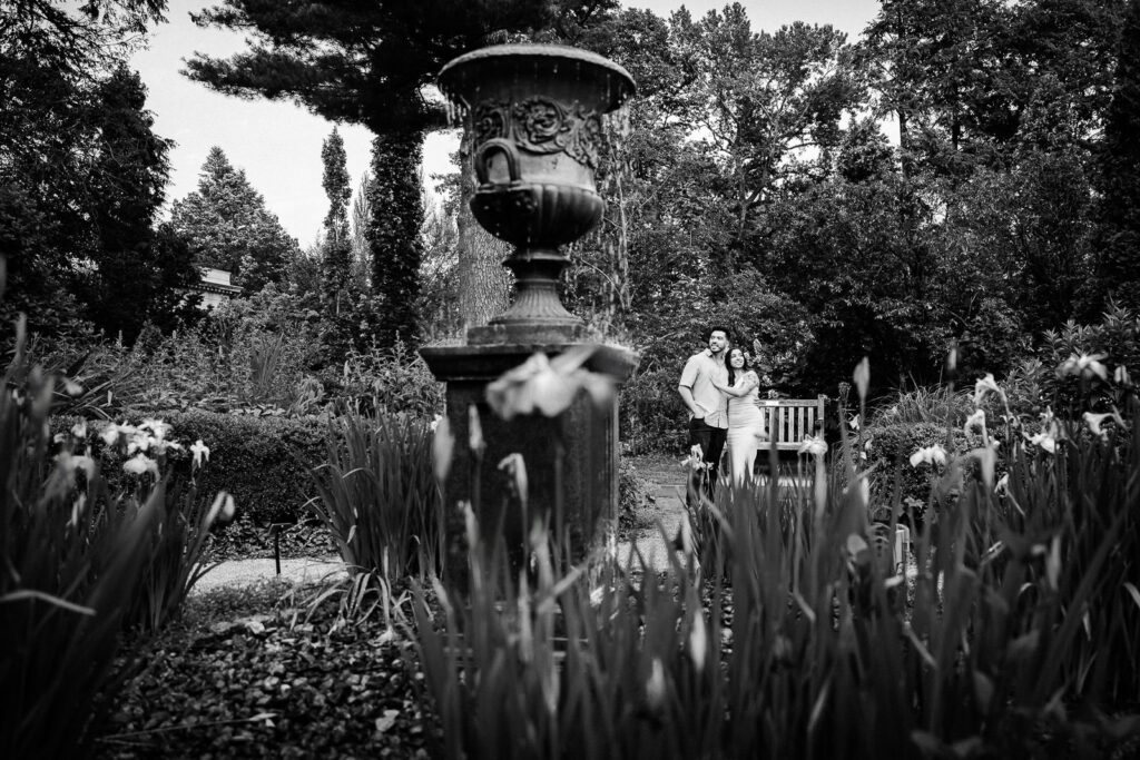 Northern NJ engagement photographer Alex Kaplan captures artistic black and white portrait in iris gardens with fountain