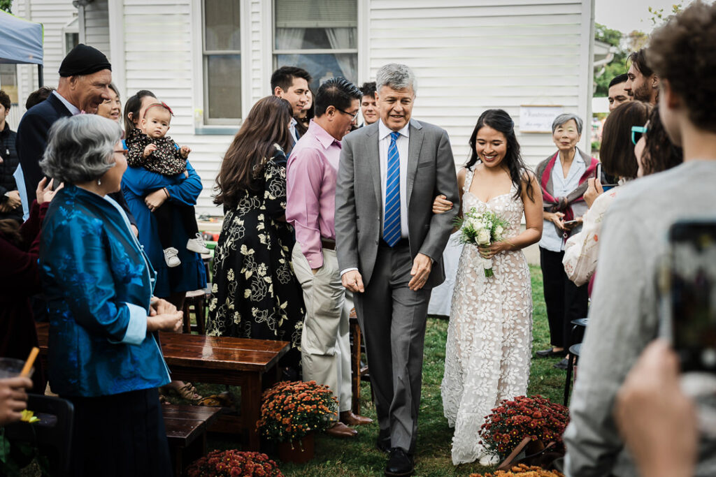 Couple exchanging vows during intimate backyard wedding ceremony in NJ