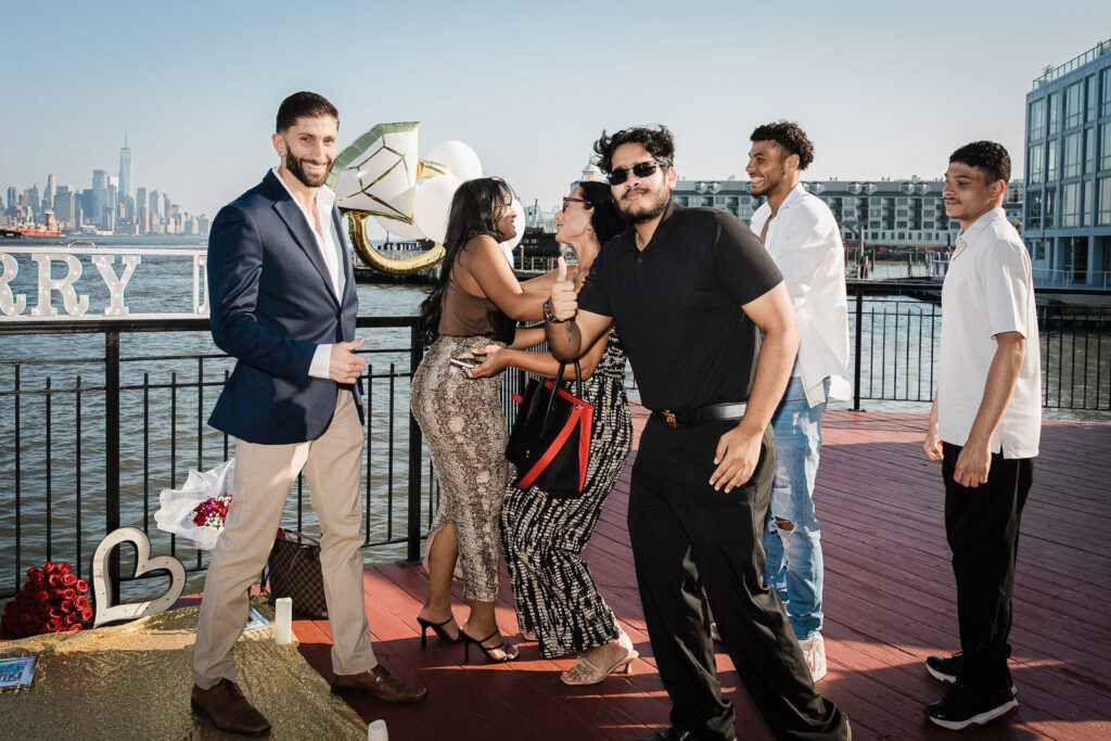 Family and friends celebrating Chart House proposal moment by Alex Kaplan Photography